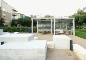 Slatted cabanas provide shaded seating for social gatherings in residential communities