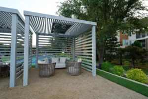 Slatted cabana provides a serene garden retreat with cozy lounge seating