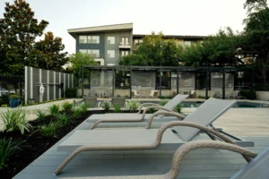 Slatted cabanas offer privacy and shade for stylish poolside lounging